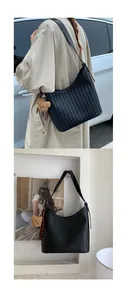 Detail of black woven shoulder bag with plush bear charm and crossbody strap