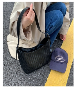 Outdoor close-up of black woven hobo bag showing high-quality twill texture and large capacity