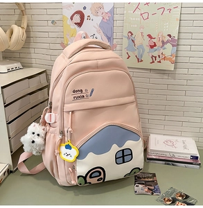 Pink large-capacity nylon backpack detail featuring a cute house-shaped pocket and charms