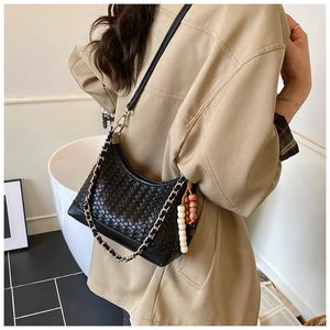 Detail of black woven hobo bag with silver chain strap and vintage beaded charms