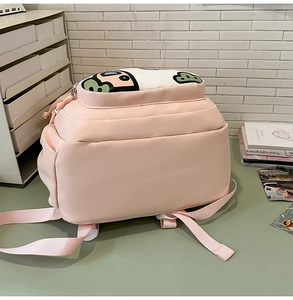 Detailed view of pink school backpack featuring a cute Among Us character cartoon print