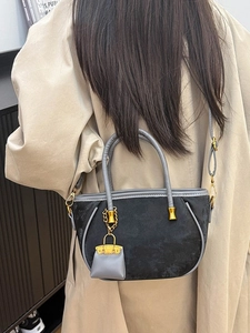Women's black suede and grey leather tote bag with gold hardware and chain charm