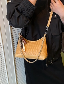 Vintage woven khaki crossbody bag with silver chain and bead charm on model
