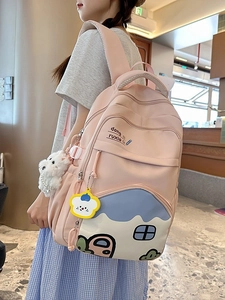 Pink cartoon school backpack with cute plush charm and spacious compartments for girls