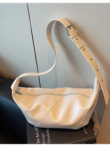 Minimalist cream crescent leather shoulder bag with diagonal stitching and wide strap