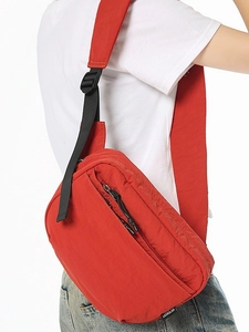 Red minimalist crossbody chest bag with multiple compartments and adjustable strap for sports