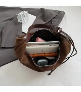Detail view of large brown suede tote bag interior showing ample space for daily essentials