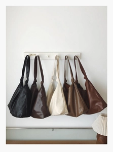Collection of minimalist leather hobo tote bags with knot detail in various earthy tones
