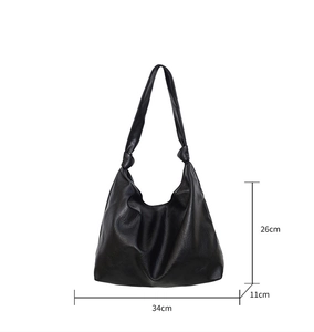 Detailed view of black PU leather hobo bag with knotted strap and 34cm x 26cm x 11cm size