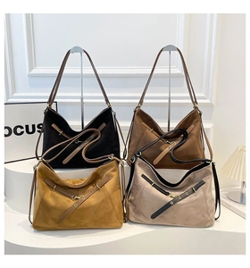 Four colors of frosted leather tote bags with metal eyelet belts on a white display stand