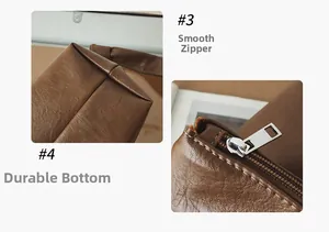 Detail view of smooth silver zipper and reinforced wear-resistant bottom on brown leather tote