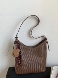 Brown woven hobo bucket bag with adjustable shoulder strap and cute bear charm