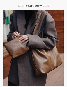 Detail of vintage brown tote bag set with matching zippered pouch on shoulder model
