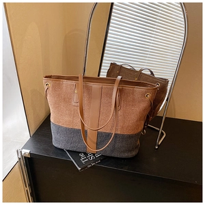 Detailed close-up of large patchwork wool tote bag with brown leather handles