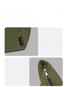 Détail du sac bandoulière en nylon vert foncé avec fermeture éclair argentée et étiquette tissée
