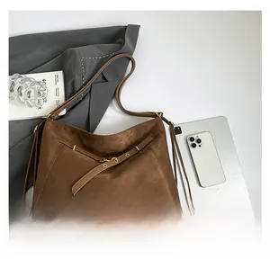 Deep brown matte hobo bag detail with vintage metal buckle and leather straps