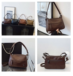 Detail view of retro square shoulder bags in dark brown and black with metal logo accents