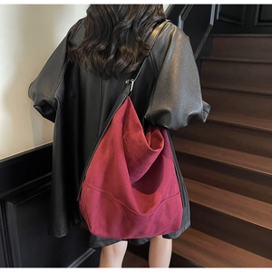 Oversized wine red suede tote bag shown in use on a shoulder for daily commute