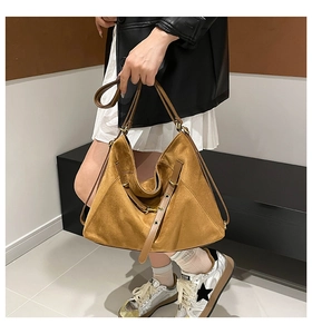 Caramel suede hobo bag with gold hardware shown on model for autumn winter style