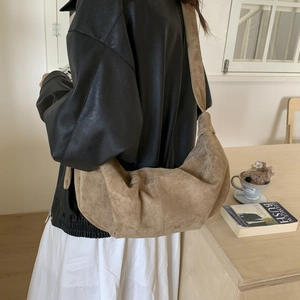 Detail of vintage khaki suede dumpling bag showing its soft texture and large capacity