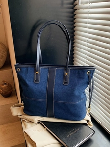 Large capacity dark blue denim tote bag with leather trim and contrast stitching details