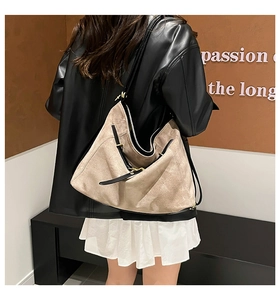 Detail of khaki suede tote bag with black slim straps and elegant golden metal buckle