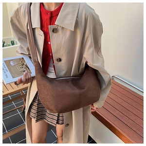 Brown hobo shoulder bag with matte finish shown in an autumn street style fashion setting