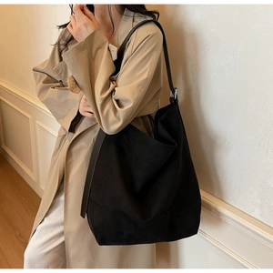Detail of black matte tote bag showing high-quality texture and leather straps