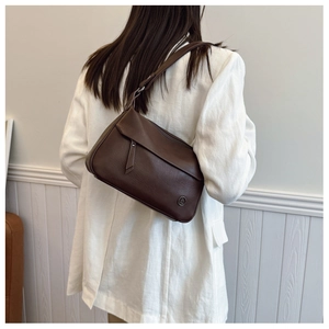 Brown vintage square shoulder bag on model showing size ratio and smooth leather texture