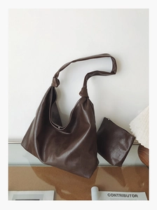 Detail of dark brown tote bag with matching inner pouch and knotted shoulder strap