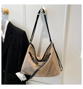 Detail of khaki frosted hobo bag with black leather straps and gold metal hardware