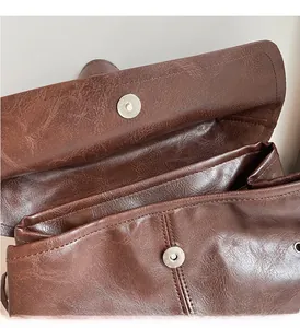 Detail shot of the vintage bucket bag featuring dual magnetic buckles and polished hardware
