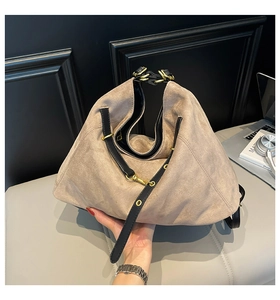 Detail view of khaki matte leather tote bag featuring elegant round metal handles