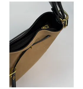 Detail view of large retro tote bag featuring brown suede texture and gold zipper hardware