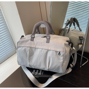 Detail of large travel tote bag with fine grid pattern texture and comfortable handles