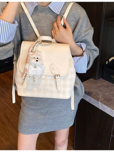 Fashionable checkered cream backpack with a plush charm accessory for women and students