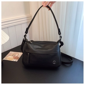 Detailed view of black litchi pattern leather bag with dual straps and silver metal logo