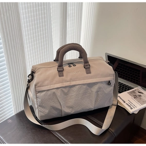 Detail of the durable fabric texture and reinforced mesh bottom of the travel duffel bag