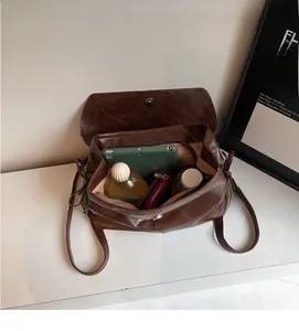 Detail view of the spacious inner compartment of the vintage brown leather backpack