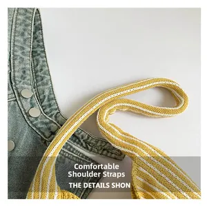 Macro detail of soft yellow and white striped knit shoulder strap with silver buckle