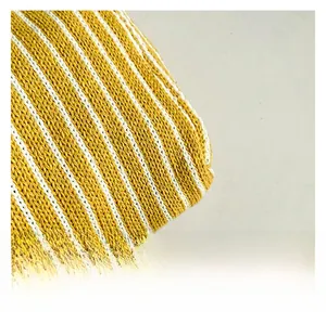 Close-up of yellow and white striped knitted fabric texture with breathable weave detail