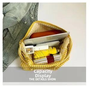 Top view of striped knit tote bag showing spacious interior with tablet and umbrella