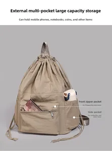 Detail view of khaki drawstring backpack with front zip pocket and side water bottle holder