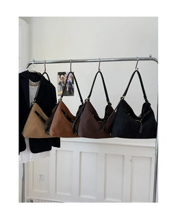Detailed view of large hobo bags in four colors with suede texture and metal buckles