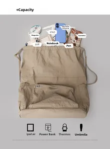 Top view of beige nylon backpack showing large capacity with tablet and daily essentials