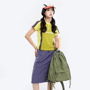 Detail of army green nylon drawstring backpack with sporty color-block outfit