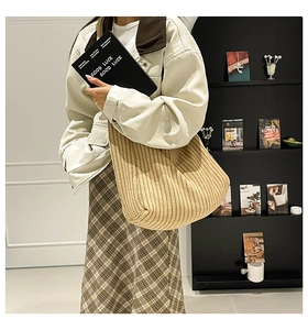 Detail of khaki ribbed knit tote bag showing the vertical texture and soft material
