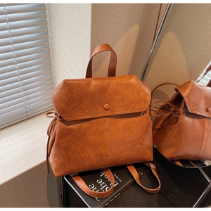Detailed view of British vintage brown leather backpack with flap and drawstring