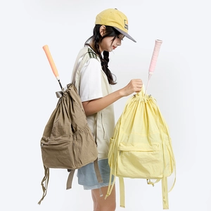 Detail view of water-resistant drawstring backpack holding a badminton racket