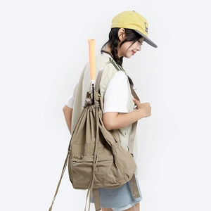 Detail of khaki drawstring backpack side view showing large capacity and racquet storage